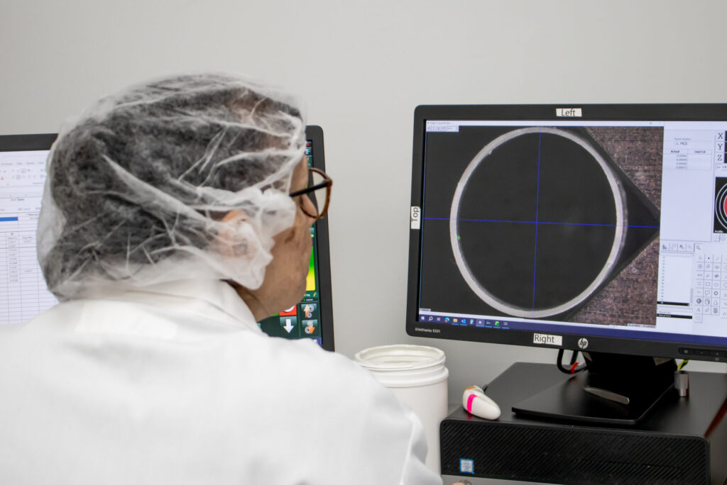 Quality technician reviewing thin wall extrusion tubing